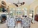 Bright living room featuring high ceilings, fireplace, and cozy seating arrangement at 128 Godfrey Rd, Edgewater, FL 32141
