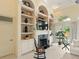 Living room with fireplace, built-in shelving, and views of the pool at 128 Godfrey Rd, Edgewater, FL 32141