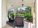 Screened patio featuring comfortable seating and a view of the beautifully landscaped yard at 128 Godfrey Rd, Edgewater, FL 32141