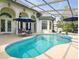 A refreshing screened-in pool and patio area, perfect for outdoor entertaining and relaxation at 128 Godfrey Rd, Edgewater, FL 32141