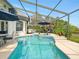 Inviting screened pool area with comfortable lounge seating and lovely tile accents at 128 Godfrey Rd, Edgewater, FL 32141