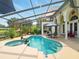 Gorgeous backyard pool and spa with screened enclosure and outdoor patio furniture at 128 Godfrey Rd, Edgewater, FL 32141