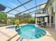 Relaxing screened-in pool and spa area with comfortable seating and tropical landscaping at 128 Godfrey Rd, Edgewater, FL 32141