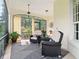 Relaxing screened porch features comfortable seating and calming natural light at 128 Godfrey Rd, Edgewater, FL 32141