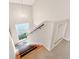 Stairway features wood treads, carpet runners, handrail, and a window for natural light at 128 Godfrey Rd, Edgewater, FL 32141