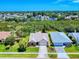 Suburban homes nestled among lush green trees and blue skies on a sunny day at 1307 Wayne Ave, New Smyrna Beach, FL 32168