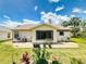 Spacious backyard featuring a patio, well-maintained lawn, and lovely landscaping, perfect for outdoor enjoyment at 1307 Wayne Ave, New Smyrna Beach, FL 32168