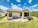 Well-maintained backyard with a patio area, lush green lawn, and mature landscaping and room for a garden at 1307 Wayne Ave, New Smyrna Beach, FL 32168