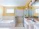 Bathroom featuring a tub, separate glass shower, bright lighting and modern fixtures at 1307 Wayne Ave, New Smyrna Beach, FL 32168