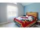 Bright bedroom features a high ceiling and a large window at 1307 Wayne Ave, New Smyrna Beach, FL 32168