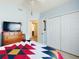 Bedroom features a large bed, a dresser, and a closet at 1307 Wayne Ave, New Smyrna Beach, FL 32168