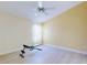 Bright bedroom with a ceiling fan and workout bench at 1307 Wayne Ave, New Smyrna Beach, FL 32168
