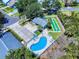 Aerial view of a community pool with lounge chairs, shuffleboard court, parking, and clubhouse at 1307 Wayne Ave, New Smyrna Beach, FL 32168