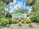 The Tymber Trace community sign surrounded by lush greenery welcomes residents and visitors at 1307 Wayne Ave, New Smyrna Beach, FL 32168