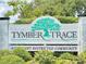 Welcoming Tymber Trace community sign amidst lush greenery, showcasing a covenant-restricted neighborhood at 1307 Wayne Ave, New Smyrna Beach, FL 32168