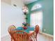 Cozy dining area features a unique hanging lamp, and natural light from the arched window at 1307 Wayne Ave, New Smyrna Beach, FL 32168