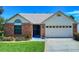 Charming one-story brick home with manicured lawn and a two car garage in a suburban neighborhood at 1307 Wayne Ave, New Smyrna Beach, FL 32168