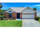 Charming one-story brick home with manicured lawn and a two car garage in a suburban neighborhood at 1307 Wayne Ave, New Smyrna Beach, FL 32168