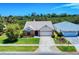 Charming one-story brick home with manicured lawn and a two car garage in a suburban neighborhood at 1307 Wayne Ave, New Smyrna Beach, FL 32168