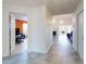 Open hallway leading to a living area and office space with neutral tile flooring and natural light at 1307 Wayne Ave, New Smyrna Beach, FL 32168