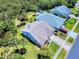 Aerial view of the home with lush landscaping and a well-maintained lawn and long driveway at 1307 Wayne Ave, New Smyrna Beach, FL 32168
