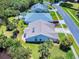Aerial view of the home with lush landscaping and a well-maintained lawn with mature trees at 1307 Wayne Ave, New Smyrna Beach, FL 32168