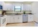 Bright kitchen features white cabinets, granite countertops, and stainless steel appliances at 1307 Wayne Ave, New Smyrna Beach, FL 32168