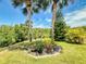 Lush, tropical landscaping with palm trees and vibrant flowers, adding to the property's curb appeal at 1307 Wayne Ave, New Smyrna Beach, FL 32168