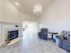Inviting living room featuring a fireplace, chandelier, and spacious layout perfect for relaxation at 1307 Wayne Ave, New Smyrna Beach, FL 32168