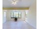 Bright living room with a large window offering natural light and serene views of the outdoors at 1307 Wayne Ave, New Smyrna Beach, FL 32168