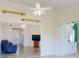 Open-concept living area featuring modern lighting fixtures and seamless transition to the kitchen at 1307 Wayne Ave, New Smyrna Beach, FL 32168