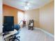 A bright, cozy office with a ceiling fan and a large window at 1307 Wayne Ave, New Smyrna Beach, FL 32168