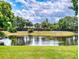 Scenic view of pond, reflecting the sky and trees, adding to the community's natural beauty at 1307 Wayne Ave, New Smyrna Beach, FL 32168
