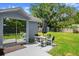Backyard patio with outdoor seating, umbrella, and spacious lawn at 135 12Th St, Daytona Beach, FL 32117