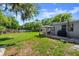 Spacious backyard with gazebo, swing set, lush lawn, and mature landscaping at 135 12Th St, Daytona Beach, FL 32117