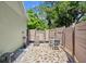 Private backyard patio with outdoor seating, stone pavers and privacy fence at 135 12Th St, Daytona Beach, FL 32117