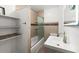 Well-lit bathroom features modern fixtures, including a sleek vanity and a glass-enclosed shower at 135 12Th St, Daytona Beach, FL 32117