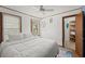 Bright bedroom with paneled walls, a plush bed, and a view of the outdoors through the windows at 135 12Th St, Daytona Beach, FL 32117