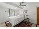 Bright bedroom with a ceiling fan, bedside table, and red rug at 135 12Th St, Daytona Beach, FL 32117