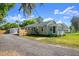 Charming single-story home featuring a well-maintained lawn and a driveway leading to a detached garage at 135 12Th St, Daytona Beach, FL 32117