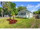 Charming house with green paint, well-maintained lawn and garden at 135 12Th St, Daytona Beach, FL 32117