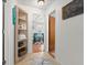Hallway leading to dining area with hardwood floors, light blue chairs and a modern wooden table at 135 12Th St, Daytona Beach, FL 32117