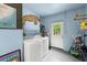 Functional laundry room with washer, dryer, and ample storage space at 135 12Th St, Daytona Beach, FL 32117