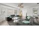 Comfortable living room featuring gray leather sofas, ceiling fan, and abundant natural light at 135 12Th St, Daytona Beach, FL 32117