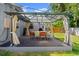 Outdoor living space includes a covered patio with stylish furniture, perfect for entertaining at 135 12Th St, Daytona Beach, FL 32117