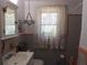 Cozy bathroom with a decorative window, tiled walls, and vintage fixtures at 1627 Umbrella Tree Dr, Edgewater, FL 32132
