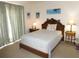 Inviting bedroom features tropical artwork, decorative curtains, and a comfortable bed at 1627 Umbrella Tree Dr, Edgewater, FL 32132