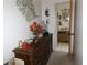 Bedroom with an ensuite bathroom, featuring a wooden dresser and decorative wall accents at 1627 Umbrella Tree Dr, Edgewater, FL 32132