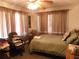 Comfortable bedroom with natural light, a ceiling fan, and warm drapes at 1627 Umbrella Tree Dr, Edgewater, FL 32132