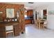 Open concept dining area and desk with wood-paneled accent wall adjacent to the kitchen at 1627 Umbrella Tree Dr, Edgewater, FL 32132